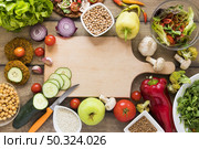 cutting board surrounded by vegetables. Стоковое фото, агентство Ingram Publishing / Фотобанк Лори