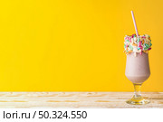 front view delicious milkshake yellow background. Стоковое фото, агентство Ingram Publishing / Фотобанк Лори