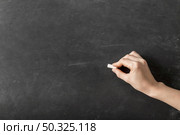 person writing with chalk empty blackboard . Resolution and high quality beautiful photo. person writing with chalk empty blackboard . High quality and resolution beautiful photo concept. Стоковое фото, агентство Ingram Publishing / Фотобанк Лори