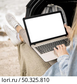 young woman browsing laptop on road trip. Resolution and high quality beautiful photo. young woman browsing laptop on road trip. High quality and resolution beautiful photo concept. Стоковое фото, агентство Ingram Publishing / Фотобанк Лори