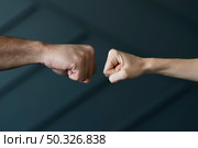 close up friends ready touch fists. Beautiful photo. close up friends ready touch fists. Стоковое фото, агентство Ingram Publishing / Фотобанк Лори