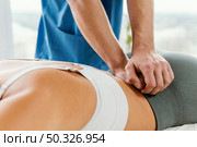male osteopathic therapist checking female patient s lower back spine. Beautiful photo. male osteopathic therapist checking female patient s lower back spine. Стоковое фото, агентство Ingram Publishing / Фотобанк Лори