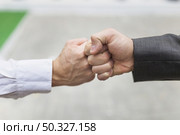crop men bumping fists. High resolution photo. crop men bumping fists. High quality photo. Стоковое фото, агентство Ingram Publishing / Фотобанк Лори