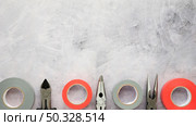 insulating tape plier arranged row white cement concrete floor. High resolution photo. insulating tape plier arranged row white cement concrete floor. High quality photo. Стоковое фото, агентство Ingram Publishing / Фотобанк Лори