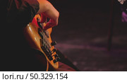 Close-up of a bassist's hand playing an electric bass guitar professionally. Five-string bass with a beautiful wooden deck. Concert of a jazz band. Стоковое видео, видеограф Воловодов Владимир / Фотобанк Лори