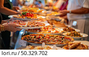 Wide array of pizzas and various food items laid out in a buffet line for guests to serve themselves. Стоковое AI-изображение, AI-художник Данила Большаков / Фотобанк Лори