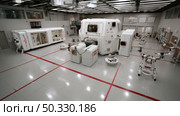Zero-gravity space lab with robotic experiment modules. Cargo spaceship on orbit of planet Earth. Exploration of space. Стоковое AI-изображение, AI-художник ALLA YURTAYEVA / Фотобанк Лори