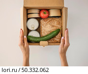 flat lay hand holding box food donation. High resolution photo. flat lay hand holding box food donation. High quality photo. Стоковое фото, агентство Ingram Publishing / Фотобанк Лори