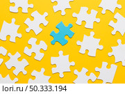 blue puzzle with white jigsaw piece yellow background. Стоковое фото, агентство Ingram Publishing / Фотобанк Лори