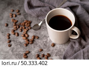 cup coffee with coffee beans spoon. Стоковое фото, агентство Ingram Publishing / Фотобанк Лори