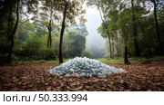 There is a lot of garbage in the forest. The concept of human pollution of forests and nature. A terrible dump in the woods. Стоковое AI-изображение, AI-художник ALLA YURTAYEVA / Фотобанк Лори