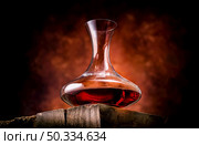 Wine in a decanter on a wooden table. Wine in a decanter. Стоковое фото, агентство Ingram Publishing / Фотобанк Лори