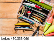 fishing float lure with plier wooden desk. Стоковое фото, агентство Ingram Publishing / Фотобанк Лори