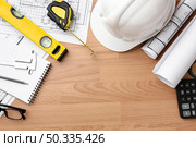 technical plan drawing with spirit level construction hat. Стоковое фото, агентство Ingram Publishing / Фотобанк Лори
