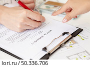 high angle man signing house contract. Стоковое фото, агентство Ingram Publishing / Фотобанк Лори