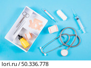 open first aid kit with medical equipments blue background. Стоковое фото, агентство Ingram Publishing / Фотобанк Лори