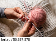 high view person knitting with pink thread. Стоковое фото, агентство Ingram Publishing / Фотобанк Лори