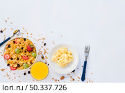 scrambled eggs juice glass cornflakes with dried fruits white background. Стоковое фото, агентство Ingram Publishing / Фотобанк Лори