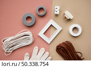 wire plug button insulating tape glove dual background. Стоковое фото, агентство Ingram Publishing / Фотобанк Лори