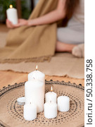 woman meditating with tray with candles. Стоковое фото, агентство Ingram Publishing / Фотобанк Лори
