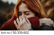 Thoughtful woman hiding her face with a scarf, partially concealing her features. Стоковое AI-изображение, AI-художник Данила Большаков / Фотобанк Лори
