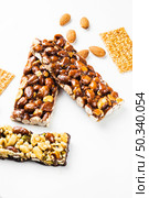 OLYMPUS DIGITAL CAMERA. granola sesame seed almonds bars white background. Стоковое фото, агентство Ingram Publishing / Фотобанк Лори