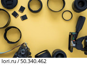professional dslr modern camera with camera accessories yellow background. Стоковое фото, агентство Ingram Publishing / Фотобанк Лори
