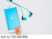 twitter app finger phone earphones. Стоковое фото, агентство Ingram Publishing / Фотобанк Лори