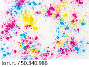 yellow pink blue holi color powder splatter white background. Стоковое фото, агентство Ingram Publishing / Фотобанк Лори