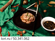 Delicious Chinese Braised Pork Knuckle Dish With Sauce and Spices. Стоковое фото, фотограф Aleksandr Golubev / Фотобанк Лори
