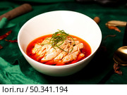 Sichuan Poached Chicken in Chili Sauce Presented in a White Bowl at a Restaurant. Стоковое фото, фотограф Aleksandr Golubev / Фотобанк Лори