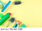 high angle view cleaning equipments yellow backdrop. Стоковое фото, агентство Ingram Publishing / Фотобанк Лори
