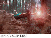 long shot woman levitating forest with lantern. Стоковое фото, агентство Ingram Publishing / Фотобанк Лори