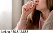 close up woman taking treatment runny nose. Стоковое фото, агентство Ingram Publishing / Фотобанк Лори