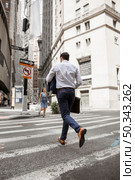 unrecognizable businessman running street. Стоковое фото, агентство Ingram Publishing / Фотобанк Лори