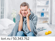 young man suffering from cold having headache. Стоковое фото, агентство Ingram Publishing / Фотобанк Лори