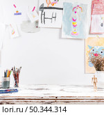 drawing table with children paintings. Стоковое фото, агентство Ingram Publishing / Фотобанк Лори