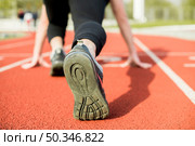 young woman runner getting ready run track. Стоковое фото, агентство Ingram Publishing / Фотобанк Лори