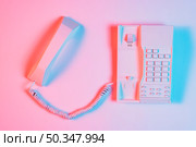 high angle view pink retro landline telephone with receiver. Стоковое фото, агентство Ingram Publishing / Фотобанк Лори