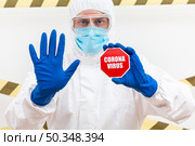 man hazmat suit with coronavirus stop sign. Стоковое фото, агентство Ingram Publishing / Фотобанк Лори