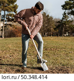 man using shovel dig hole planting tree. Стоковое фото, агентство Ingram Publishing / Фотобанк Лори