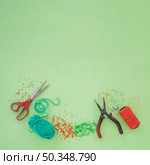scissor plier wool beads orange yarn spool green background. Стоковое фото, агентство Ingram Publishing / Фотобанк Лори