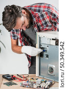young male technician examining computer workshop. Стоковое фото, агентство Ingram Publishing / Фотобанк Лори
