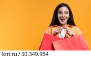 excited woman holding shopping bags with. Стоковое фото, агентство Ingram Publishing / Фотобанк Лори