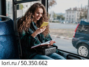 woman with curly hair travelling with bus. Стоковое фото, агентство Ingram Publishing / Фотобанк Лори