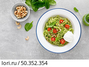 Pasta with spinach pesto, cashew nuts and soft cream cheese. Top view. Стоковое фото, агентство Ingram Publishing / Фотобанк Лори