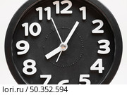 close up black wall clock face white background. Стоковое фото, агентство Ingram Publishing / Фотобанк Лори