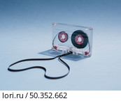 close up shot clear cassette tape gradient background. Стоковое фото, агентство Ingram Publishing / Фотобанк Лори