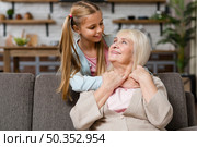 grandmother granddaughter looking each other medium shot. Стоковое фото, агентство Ingram Publishing / Фотобанк Лори