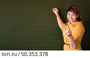 teacher pointing chalkboard with copy space. Стоковое фото, агентство Ingram Publishing / Фотобанк Лори